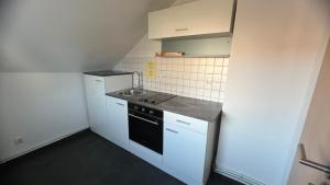 a small kitchen with a sink and a stove at Ferienwohnung in Wesel
