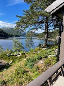 a view of a lake from the porch of a house at Beautiful Cottage by the Sea in Tysse