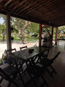 a wooden table and chairs on a patio at Camping MotorHome Caiçara in Caiçara