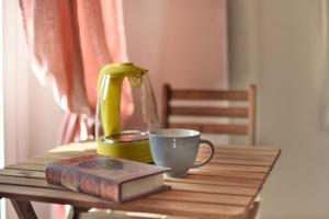 a tea pot and a book and a cup on a table at L'altro Tempo in Vercelli