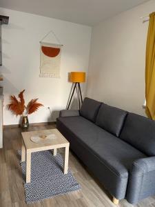 a living room with a blue couch and a table at Nerezinka in Nerezine