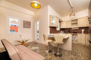 a kitchen and living room with a couch and a table at The Z House Santorini in Fira