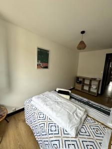 a bedroom with a bed with a blanket on it at Beau T3 coeur village in Gruissan