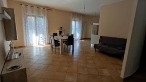 a living room with a table and a couch at Residenza Di Lorenzo in Mondragone