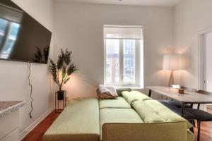 una sala de estar con un sofá y una mesa en Fox Aparthotel Palais Des Congres IV, en Montreal