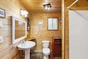 a bathroom with a toilet and a sink at Laura Mar Artist's Retreat in Otter Rock