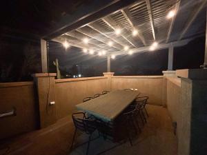 a table and chairs on a balcony at night at Downtown La Mesa gem in La Mesa