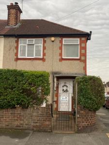 a house with a gate with a sign on it at LARGE bedroom SINGLE bed in Feltham +14 photos
