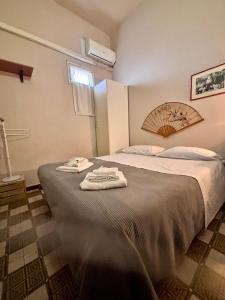 a bedroom with a bed with towels on it at Holiday home for groups Acireale in Santa Tecla