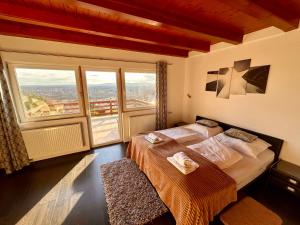 a bedroom with a bed and a large window at Villa Somlyó in Fót +46 photos