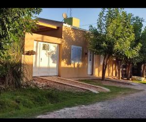 a house with a white door on the side of it at Casa quinta La Ruchi in San Andrés de Giles