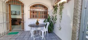 a table and chairs sitting on a patio at Cantinho do ACE in Vila Velha