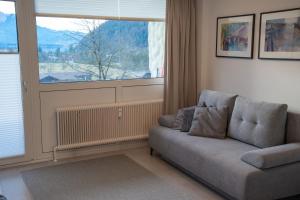 a living room with a couch and a window at Apartment Seezeit in Strobl