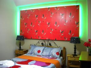 a bedroom with a bed with a red head board at Chios Rooms MyView in Karfas