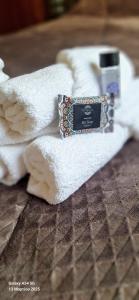 a pile of towels and a bottle of soap on a bed at MARY'S HOUSE - Urban Promenade Vibes in Tripolis +99 photos