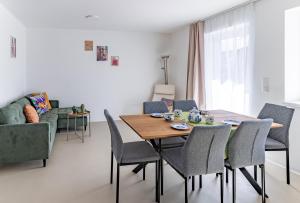 a dining room with a table and chairs and a couch at F13 apartments in Altenberg bei Linz