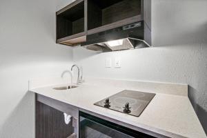 a kitchen with a sink and a counter top at Southern Suites Kennesaw in Kennesaw