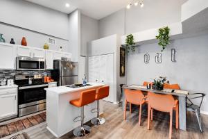 a kitchen with orange chairs and a table in it at New 3bedroom 2 Bath condo with water view, walking to the beach in Hallandale Beach