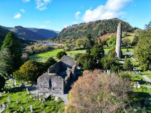 an image of a cemetery with a monument in the distance at Glendalough Sanctuary in Brockagh