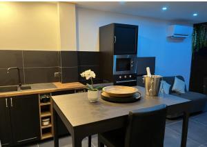 a kitchen with a table with a plate on it at La villa les Bermudes in Wasnes-au-Bac +9 photos