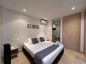 a bedroom with a large bed and a bathroom at Edificio Casa de Río in Santa Marta +32 photos