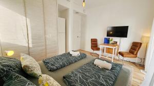 a living room with two couches and a flat screen tv at Traumschlösschen EG in Nossen