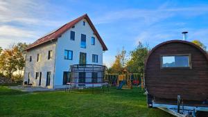 a house and a play structure in a yard at Traumschlösschen EG in Nossen