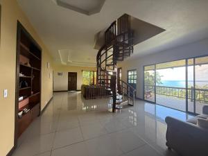 a living room with a spiral staircase in a house at Villa Susan in San Pedrillo