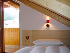 Postel nebo postele na pokoji v ubytování Mansarda Dolomiti