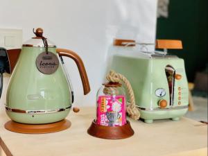 two electric toasters sitting on a counter next to a toaster at Ferienwohnung Darosa Bergblick in Seeg