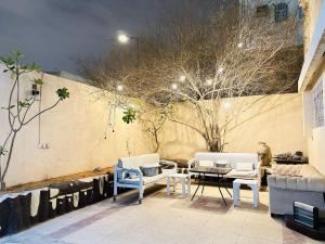 a patio with two chairs and a table at Su Casa Hostel in Riyadh