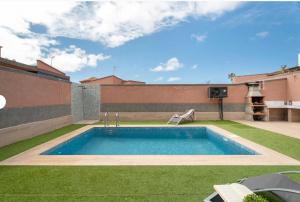 a swimming pool in the backyard of a house at Villa TEJINA BEAUTIFUL in Guía de Isora