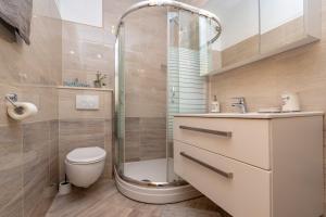 a bathroom with a shower and a toilet and a sink at Apartments and rooms by the sea Zavalatica, Korcula - 547 in Zavalatica +53 photos