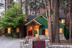 a green house with trees in front of it at Contemporary Classic on a Private Mountain Lake in Lake Arrowhead