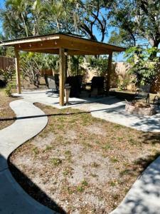 a gazebo with a table and chairs in a yard at The Beach House Escape in Bradenton +33 photos