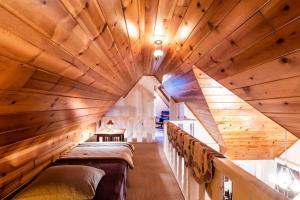 a room with a large wooden ceiling at Contemporary Classic on a Private Mountain Lake in Lake Arrowhead