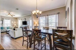 a dining room and living room with a table and chairs at Caribbean Palm 3BR Retreat King Bed Fireplace in Bolivar Peninsula