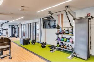 a gym with a treadmill and weights at OTR King Bed Free Parking Gym Top Floor Club Room in Cincinnati