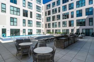 a patio with tables and chairs next to a building at OTR King Bed Free Parking Gym Top Floor Club Room in Cincinnati +44 photos
