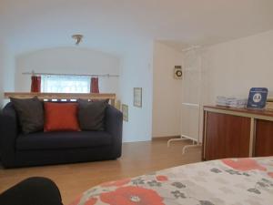 a living room with a couch and a bed at Apartament Kazimierz Brzozowa in Krakow