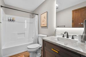 a bathroom with a sink and a toilet and a tub at 29 - Modern 5 Bedroom 2 Bath in Middletown