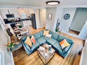 an overhead view of a living room with a blue couch at 23 COMFORT AND LUXURY 3 BR 2 BA House in Southington +8 photos