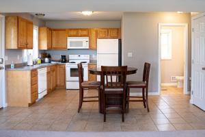 a kitchen with a table and chairs and a refrigerator at 2 Beautiful 1 BR Apartment - Central CT in Plainville