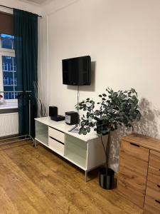 a living room with a tv on the wall at Apartament Piwna52 in Gdańsk
