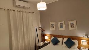 a bedroom with a bed with blue pillows at 'ESTRELA STAYS' in Lagos