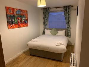 a small bed in a small room with a window at Luxury City Centre Dublin 1 Apartment in Dublin