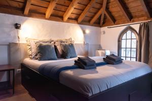 a bedroom with a large bed in a room at Casa Mourisca - Albino d'Óbidos in Óbidos