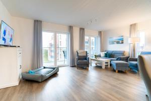 a living room with a couch and chairs at Seebreeze 50 2 N in Wangerland