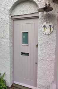 a white garage door with a sign on it at Iris Cottage in Whitstable