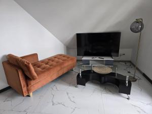 a living room with a couch and a table at Appartement Confort avec parkings gratuits in Andolsheim